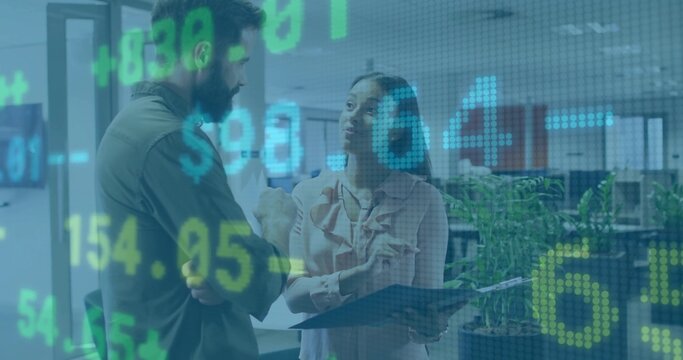 Man in green shirt, woman in blouse discussing finance in office, with clipboard stock overlay - Powered by Adobe