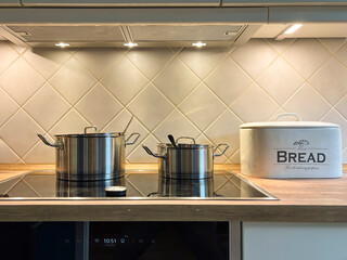 Kitchen scene with stove and pots on top.