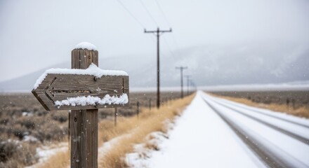 Directional signpost on a snowy rural road
