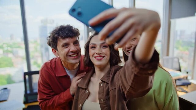 Corporate team making selfie standing modern office laughing together closeup