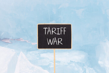 Trade tariff war symbol. Concept word Tariff war on beautiful black blackboard. Beautiful Baikal...