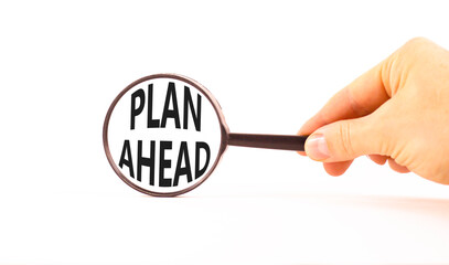 Plan ahead symbol. Concept word Plan ahead on beautiful magnifying glass. Businessman's hand. Beautiful white paper background. Black magnifying glass. Business plan ahead concept. Copy space.