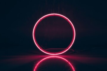 Bright pink neon circle on a dark background ring light