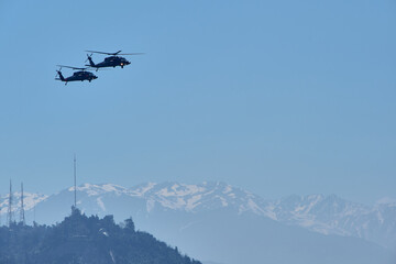 Fototapeta na wymiar Chilean Air Force helicopters in flight over Santiago de Chile