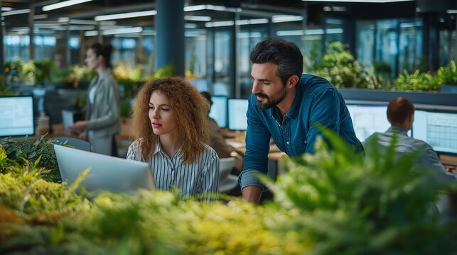 Team of professionals in modern office with abundant greenery collaborates on project, focusing on sustainability and environmental impact. atmosphere is innovative and eco friendly