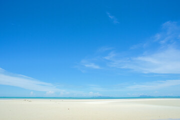 Azure Horizon: A serene landscape where a vast, cerulean sky kisses the serene, sandy shoreline, creating an atmosphere of peace and boundlessness.