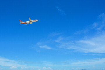 Soaring Above: An airplane gracefully ascends into a vast expanse of a clear, azure sky, embodying the spirit of travel and adventure.