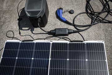 Portable Generator with Solar Panels and Electric Vehicle Charging Cable