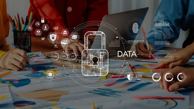 A business team collaborates in a modern workspace, focusing on data security strategies. Visual graphics emphasize protection and analytics in discussions. Raster
