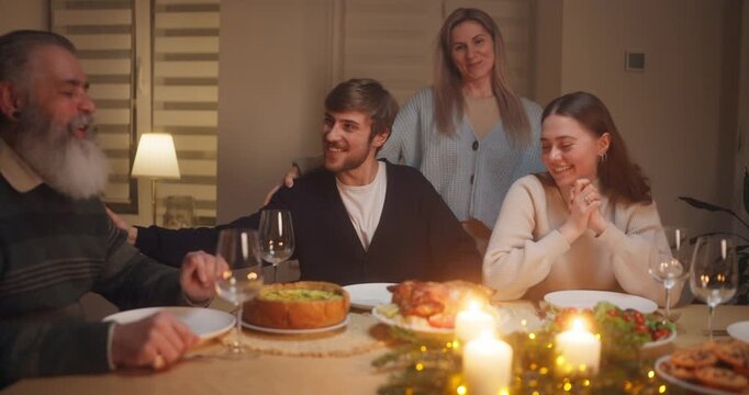 Family gathering for dinner with joyful conversations and delicious dishes around the table