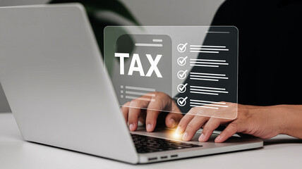 Person filing taxes online using a laptop with a digital tax form overlayed