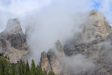 Mountain valley covered by white clouds