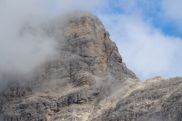 Low clouds around rocky mountain peak