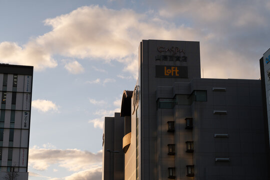 HIMEJI,  JAPAN - FEB 13, 2025: Sunset view of the Loft department store in the CASPA building, silhouetted against a cloudy sky in Japan.