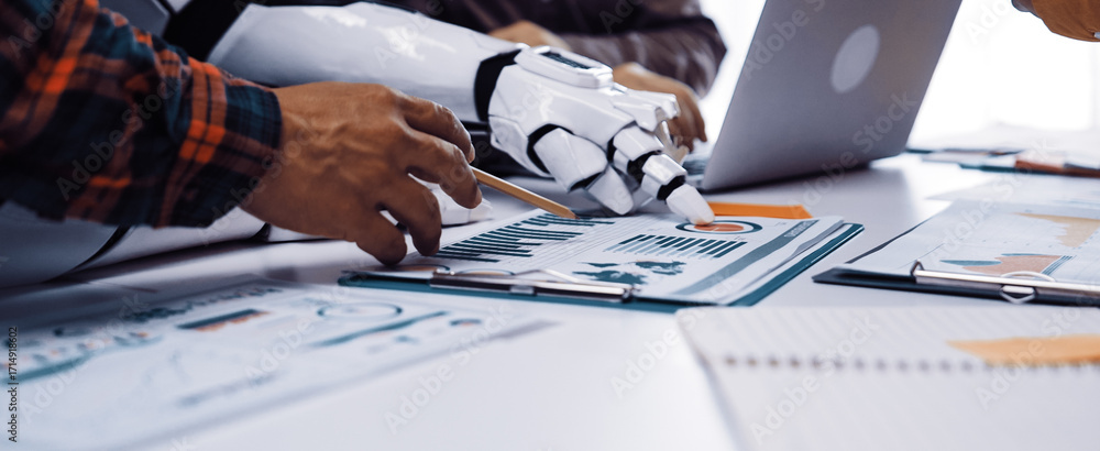 Poster a close-up view of a collaborative workspace showcasing a human hand and a robotic arm working toget