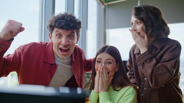 Three winners looking computer office closeup. Coworkers rejoicing achievement