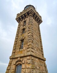 Low-angle view of a tall stone lighthouse