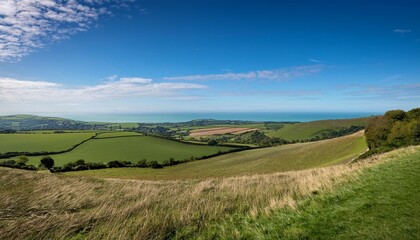 Fototapeta premium Looking Out From Itford Hill In The South Downs With The Sea Near Newhaven In The Distance And A Blue Sky Overhead