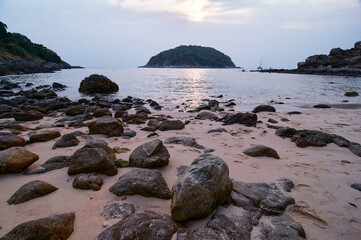 Serene Beach Landscape with Rocks and Island During Sunset