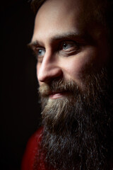 Obraz premium Portrait of a Man with a Beard in Subdued Lighting