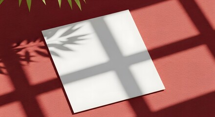 Blank white paper sheet with window and leaf shadows on a vibrant red background.