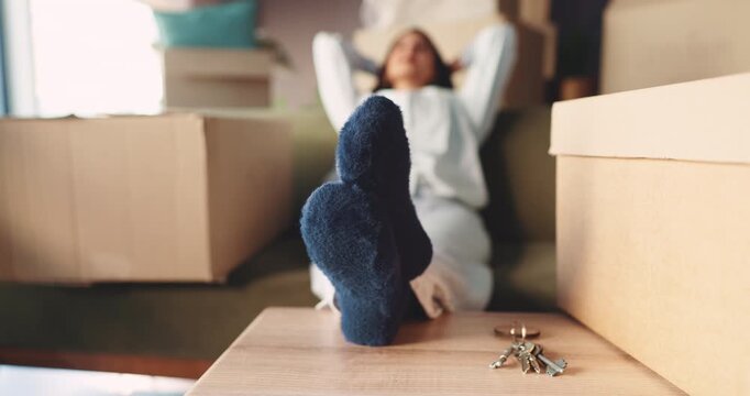 Relax, real estate and woman in new home with boxes, keys and moving to dream house. Thinking, relocation and person in apartment with socks, property investment and mortgage loan for fresh start.