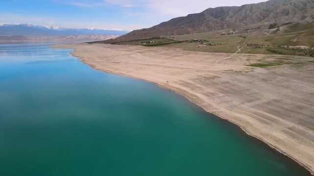 Toktogul Reservoir (284.3 km&sup2;),the largest in Central Asia.Turquoise water,sandy beaches and snow-capped Tien Shan on the horizon.Fed by the Naryn River and a major hydroelectric source (Toktogul HPP)
