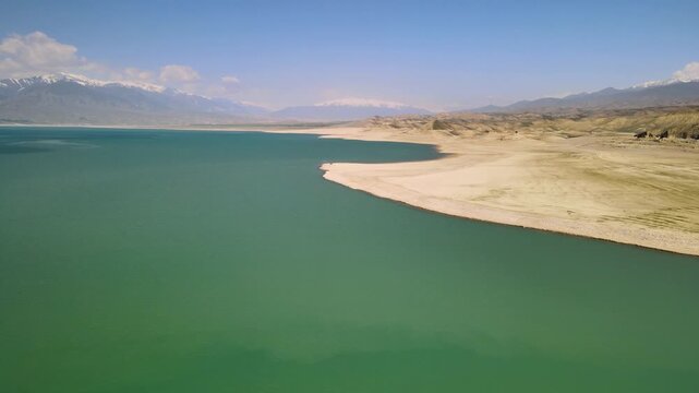 Toktogul Reservoir (284.3 km&sup2;),the largest in Central Asia.Turquoise water,sandy beaches and snow-capped Tien Shan on the horizon.Fed by the Naryn River and a major hydroelectric source (Toktogul HPP)