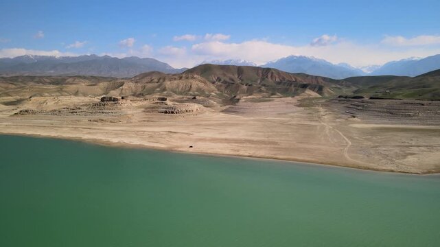 Toktogul Reservoir (284.3 km&sup2;),the largest in Central Asia.Turquoise water,sandy beaches and snow-capped Tien Shan on the horizon.Fed by the Naryn River and a major hydroelectric source (Toktogul HPP)
