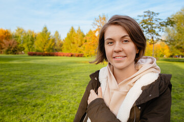 Young Woman Smiling Outdoors In Autumn Park