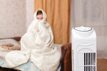 Woman Wrapped In Blanket Using Heater In Cold Room