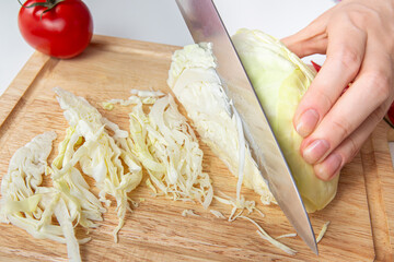 Chef Closeup Slicing White Cabbage On Wooden Cutting Board