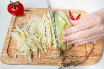 Chef Cutting White Cabbage Into Slices On Cutting Board