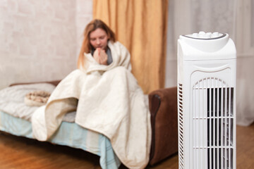Woman Wrapped In Blanket Using Heater In Cold Room