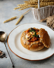 Delicious Bread Bowl Filled with Savory Stew, Fresh Herbs, and