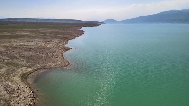 Toktogul Reservoir (284.3 km&sup2;),the largest in Central Asia.Turquoise water,sandy beaches and snow-capped Tien Shan on the horizon.Fed by the Naryn River and a major hydroelectric source (Toktogul HPP)