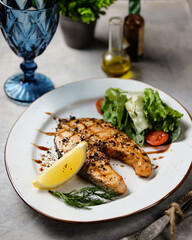 Deliciously Grilled Salmon Accompanied by Fresh Vegetables and a Zesty
