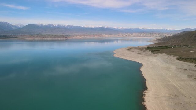 Toktogul Reservoir (284.3 km&sup2;),the largest in Central Asia.Turquoise water,sandy beaches and snow-capped Tien Shan on the horizon.Fed by the Naryn River and a major hydroelectric source (Toktogul HPP)