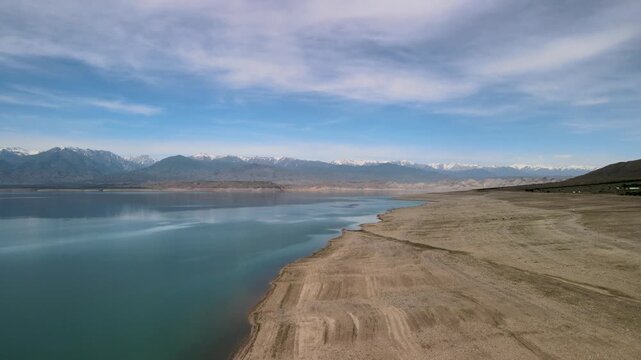 Toktogul Reservoir (284.3 km&sup2;),the largest in Central Asia.Turquoise water,sandy beaches and snow-capped Tien Shan on the horizon.Fed by the Naryn River and a major hydroelectric source (Toktogul HPP)