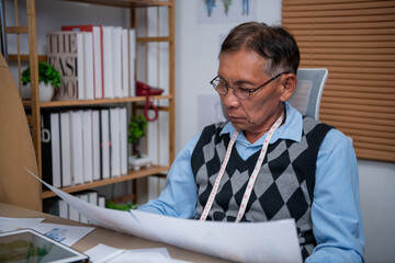 Focused man reviewing documents in a well-organized office setting.
