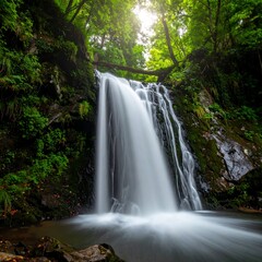 Fototapeta premium Lush waterfall cascading down rocky terrain
