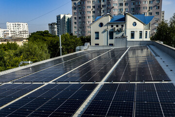 Rooftop solar panels on modern building with residential apartment blocks in the city
