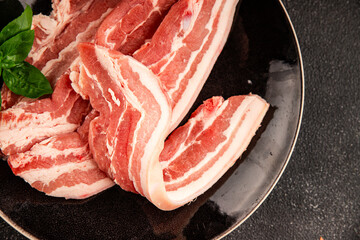 Bacon slice lard with meat slices pieces pork tenderloin portion size natural product tasty snack fresh delicious gourmet food background on the table rustic top view copy space