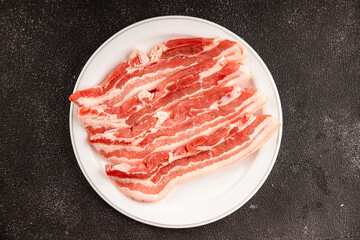 Bacon slice lard with meat slices pieces pork tenderloin portion size natural product tasty snack fresh delicious gourmet food background on the table rustic top view copy space