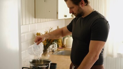 Man cooking ramen noodles. Male making noodle soup broth in the home kitchen stove. Traditional Asian food. Close Up Video Of Mans Hands Serving Pasta With Fresh Vegetables. Preparing Homemade Dish. - Powered by Adobe