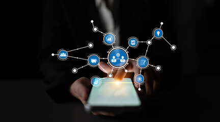 A businessperson is seen interacting with a mobile device, highlighting digital network connections. This image symbolizes modern communication and technological advancement. Tessel