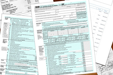 2025 tax year IRS form 1040 and made up financial notes lay on a desktop. 
