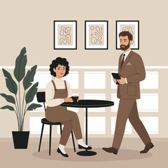 Woman at a cafe table with a waiter standing nearby taking her order