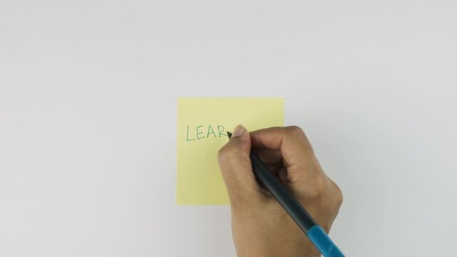 Learn a new SKILL self affirmation on yellow post it note on white wall background, self affirmation tags and healthy lifestyle stock video, 4k Hi-res