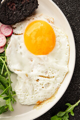 Eggs breakfast black pudding, egg, vegetables, arugula portion size natural product tasty snack fresh delicious gourmet food background on the table rustic top view copy space